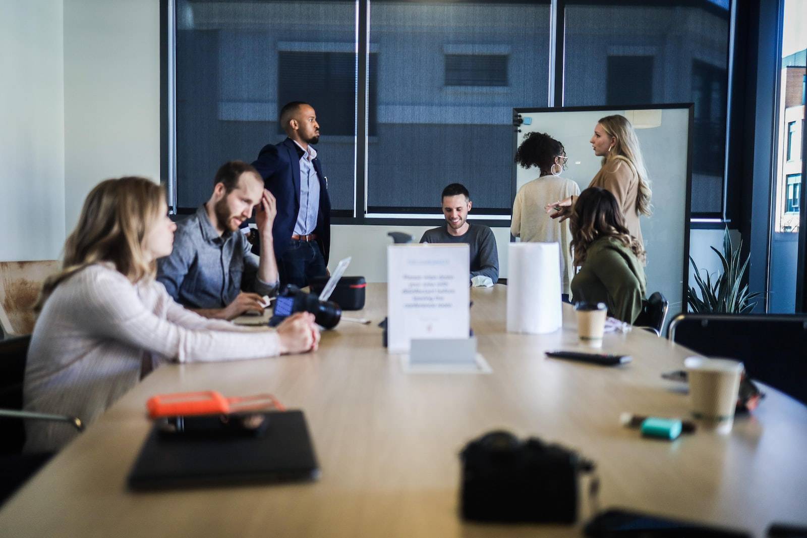 people sitting at the table in an Office team meeting